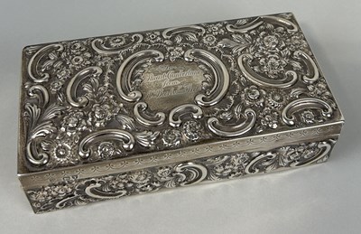 Lot 281 - A SILVER CIGARETTE BOX WITH FLORAL REPOUSSE DESIGN