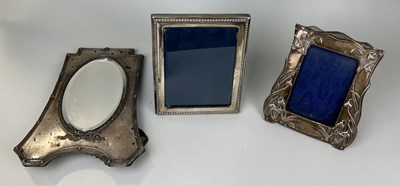 Lot 308 - THREE SILVER PICTURE FRAMES ONE ARTS AND CRAFTS