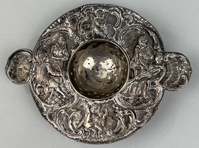 Lot 307 - A SILVER STRAINER WITH REPOUSSE DECORATION OF FIGURES