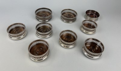 Lot 283 - A COLLECTION OF NINE SILVER WINE COASTERS (9)