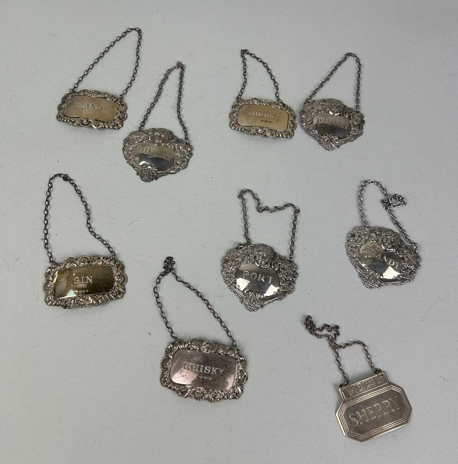 Lot 284 - A COLLECTION OF NINE SILVER BOTTLE LABELS TO INCLUDE BRANDY, WHISKEY, PORT, GIN, SHERRY (9)