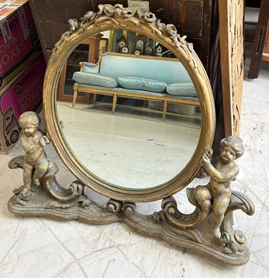 Lot 101 - A FRENCH GILDED WALL MIRROR FLANKED BY PUTTI,...