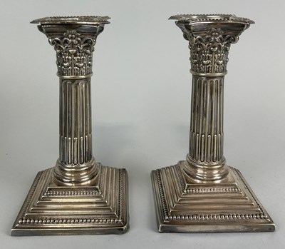 Lot 144 - A PAIR OF SILVER CORINTHIUM CANDLESTICKS,...