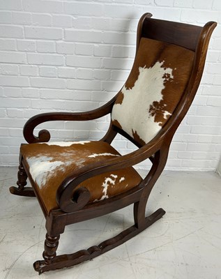 Lot 539 - AN OAK ROCKING CHAIR UPHOLSTERED IN COW HIDE...