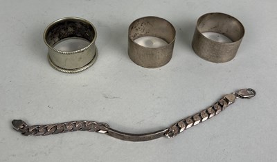 Lot 301 - THREE SILVER NAPKIN RINGS AND A SILVER BRACELET