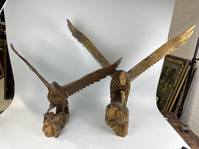 Lot 1236 - TWO LARGE CARVED WOODEN SCULPTURES DEPICTING EAGLES, ONE FIGHTING A SNAKE