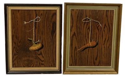 Lot 409 - FERMOR: BRITISH (ACTIVE 1960'S-70'S): A PAIR OF TROMP-L'OEIL OIL PAINTINGS ON BOARD DEPICTING A CARROT AND GARLIC HANGING WITH STRING FROM A NAIL