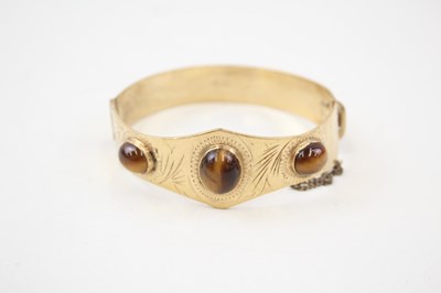 Lot 671 - A MID-CENTURY ROLLED GOLD BANGLE SET WITH...