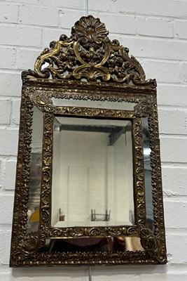 Lot 729 - A DUTCH BRASS REPOUSSE CUSHION WALL MIRROR...