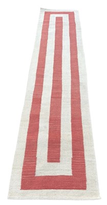 Lot 1123 - A RED AND WHITE STRIPED HALL RUG