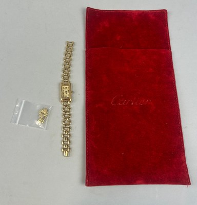 Lot 150 - A CARTIER 18CT GOLD LADIES WATCH WITH RED...