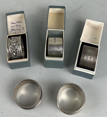 Lot 295 - FIVE SILVER NAPKIN RINGS THREE WITH BOXES (5)