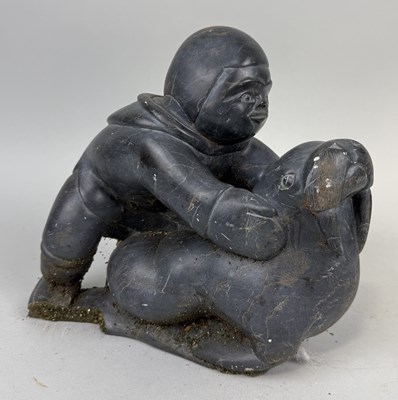 Lot 355 - A LARGE CARVED STONE INUIT SCULPTURE DEPICTING A FIGURE WITH A WALRUS