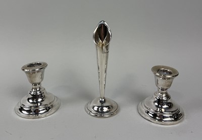 Lot 107 - A PAIR OF SILVER FILLED CANDLESTICKS ALONG WITH A SPILL VASE