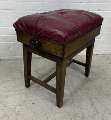 Lot 981 - A RED LEATHER UPHOLSTERED PIANO STOOL