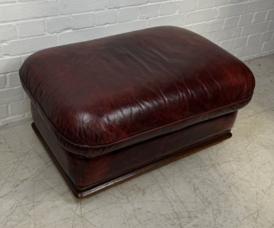 Lot 963 - A RED LEATHER UPHOLSTERED OTTOMAN FOOTSTOOL