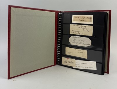 Lot 436 - A RED ALBUM OF OVER ONE HUNDRED ITEMS, TO INCLUDE CUT AUTOGRAPHS /SIGNATURES, STOCK CARDS, ETC.