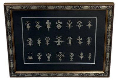 Lot 92 - A FRAMED SET OF TWENTY ONE SILVER AGADEZ CROSSES