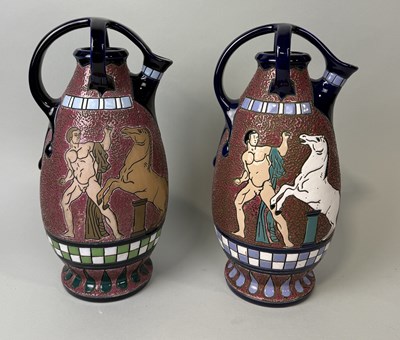 Lot 383 - A PAIR OF ART DECO CZECH AMPHORA POTTERY SPOUTED EWERS WITH CRUCIFORM HANDLES.