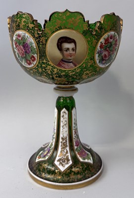 Lot 867 - A BOHEMIAN GREEN GLASS PEDESTAL BOWL WITH PAINTED FIGURAL AND FLORAL PANELS AND GILT DECORATION