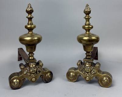 Lot 399 - A PAIR OF 19TH CENTURY BRASS FIRE DOGS WITH MASKS