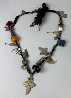 Lot 110 - AN ETHEOPIAN METAL AND AMBER CHARM NECKLACE