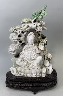 Lot 148 - A CHINESE JADE SCULPTURE DEPICTING THE SEATED GUANYIN WITH RUYI SCEPTRE, SURROUNDED BY BAMBOO SHOOTS, BIRD AND FOLIAGE