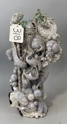 Lot 150 - A CHINESE JADE OR JADEITE SCULPTURE DEPICTING A FIGURE WITH BIRD AND FRUIT