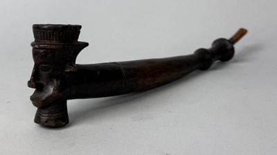 Lot 379 - AN AFRICAN WOODEN PIPE, THE BOWL CARVED WITH MAN'S FACE, 20TH CENTURY