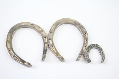 Lot 389 - THREE STERLING SILVER LUCKY HORSE SHOE TOKENS