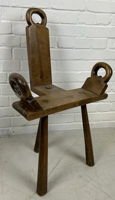 Lot 672 - A PRIMITIVE MILKING STOOL WITH THREE LEGS