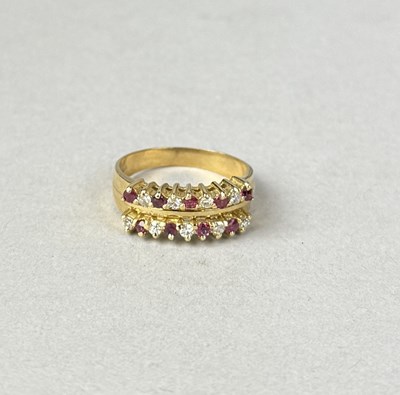 Lot 409 - A 14CT GOLD TWO ROW RUBY AND DIAMOND RING