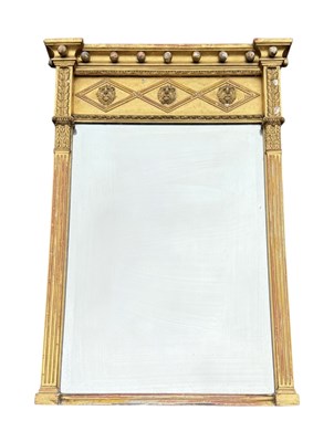 Lot 1002 - A REGENCY GILT WOOD PIER MIRROR WITH LION HEAD MASKS AND ROUNDELS