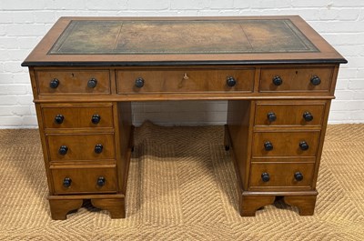 Lot 1075 - A YEW WOOD NINE DRAWER TWIN PEDESTAL DESK WITH TOOLED LEATHER TOP