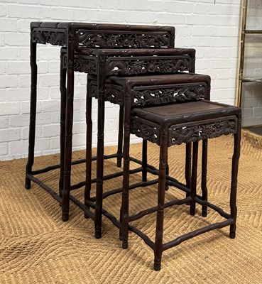 Lot 1009 - A LATE QING CHINESE HONGMU NEST OF FOUR TABLES, CARVED WITH DRAGONS