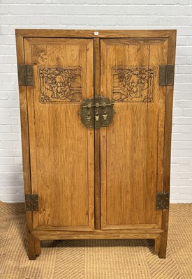 Lot 968 - A CHINESE HONGMU / HUANGHUALI CABINET CARVED WITH FIGURES