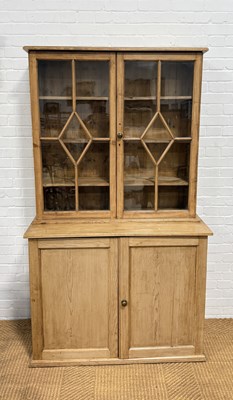 Lot 1052 - A PINE DRESSER IN TWO SECTIONS WITH GLAZED UPPER DOORS AND CUPBOARD BELOW