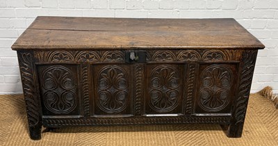 Lot 1115 - A 17TH CENTURY STYLE OAK COFFER WITH CARVED FRONT PANELS