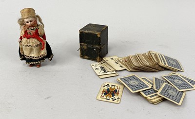 Lot 633 - AN ANTIQUE MINIATURE DOLL ALONG WITH A MINIATURE PACK OF CARDS