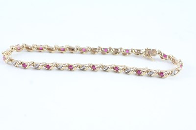 Lot 99 - A 9CT GOLD RUBY AND DIAMOND BRACELET