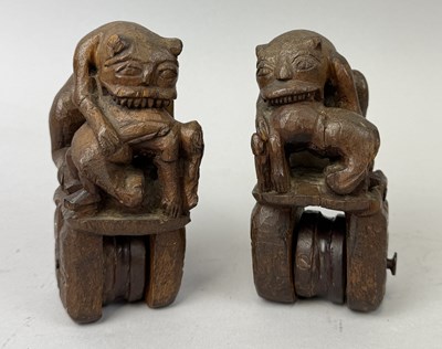Lot 590 - A PAIR OF HEDDEL PULLEYS IN THE FORM OF LIONS FEASTING ON HUMANS, POSSIBLY BAULE
