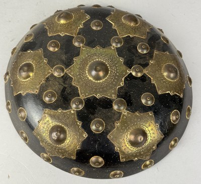 Lot 85 - AN INDONESIAN SHIELD OR BUCKLER, WOOD WITH APPLIED BRASS ORNAMENTATION, ACEH, SUMATRA, INDONESIA, CIRCA 1900
