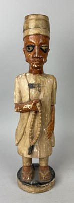 Lot 53 - A TALL AFRICAN TRIBAL CARVED WOODN SCULPTURE DEPICTING A YORUBA STANDING PRIEST IN WHITE ROBE, HOLDING A ROSARY, YORUBA POEPLE, NIGERIA, LATE 19TH CENTURY
