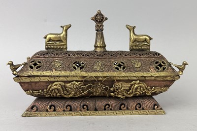 Lot 24 - A MONGOLIAN BUDDHIST PARCEL GILT COPPER CENSER TOPPED WITH TWO DEERS AND A WHEEL OF DHARMA, MONGOLIA OR CHINESE, 19TH CENTURY