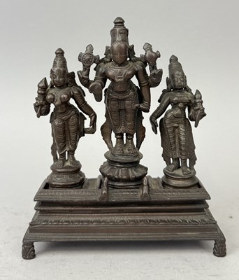 Lot 33 - INDIAN BRONZE OF VISHNU AND CONSORTS SRI DEVI AND BHU DEVI ON A STAND, SOUTH INDIA, 18TH CENTURY (4)