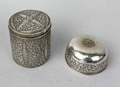 Lot 96 - THAI OR MALAY SILVER LIDDED CYLINDRICAL BOX AND MATCHED BOWL, CHASED WITH VEGETAL SCROLLWORK, MALAYSIA/THAILAND CIRCA 1910
