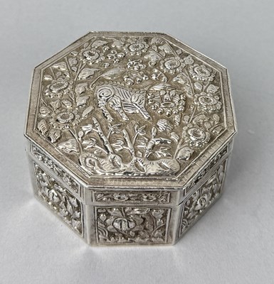 Lot 119 - A CHINESE SILVER OCTAGONAL LIDDED BOX FINELY CHASED WITH A LION AND FLOWERS, CHINA, 19TH CENTURY