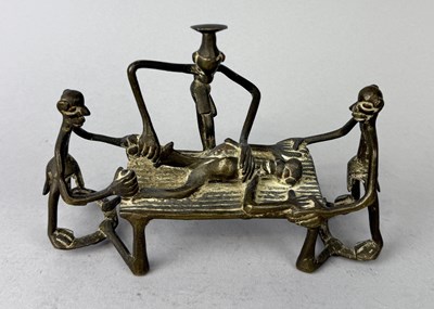 Lot 158 - A CAST BRASS GROUP DEPICTING AN AFRICAN CHIEF AND TWO HELPERS SLICING OPEN THE BELLY OF AN OPPONENT, GHANA, EARLY 20TH CENTURY