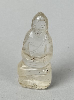 Lot 112 - A BURMESE OR CHINESE SMALL ROCK CRYSTAL IMAGE OF THE SEATED BUDDHA, BURMA OR CHINA, CIRCA 18TH CENTURY