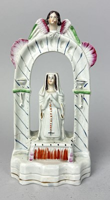 Lot 499 - STAFFORDSHIRE, A NUN PRAYING AND KNEELING ON A PAINTED STOOL UNDER AN ARCH, CIRCA 1870'S